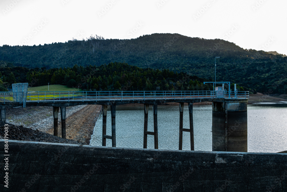 Sun setting over the Waitakrie Dam. auckland, New Zealand Sun setting over the Waitakrie Dam. auckland, New Zealand