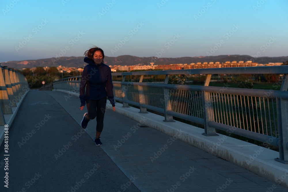 Woman running very early in the morning, in Barcelona, Spain.