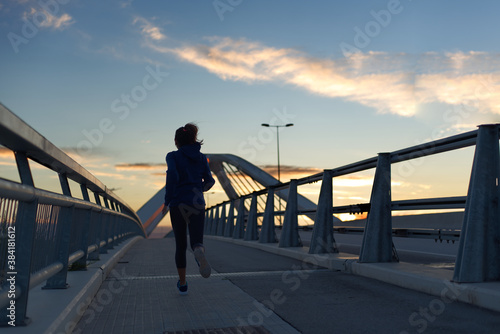 Bild auf Leinwand Woman running very early in the morning, in Barcelona, Spain.