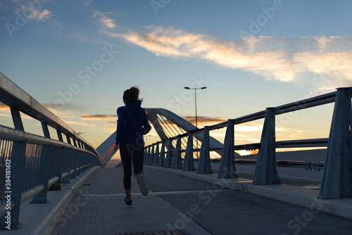 Woman running very early in the morning, in Barcelona, Spain.