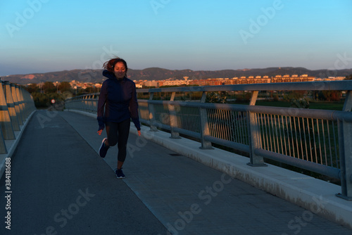 Woman running very early in the morning  in Barcelona  Spain.