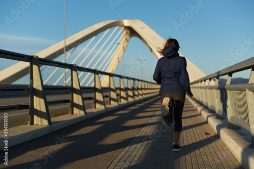 Woman running very early in the morning, in Barcelona, Spain. © Gusta Cabrera