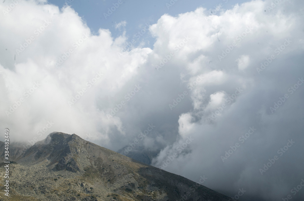 The peaks in mountain Pirin on background of dramatic sky storm clouds The peaks in mountain Pirin on background of dramatic sky storm clouds