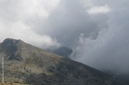 The peaks in mountain Pirin on background of dramatic sky storm clouds