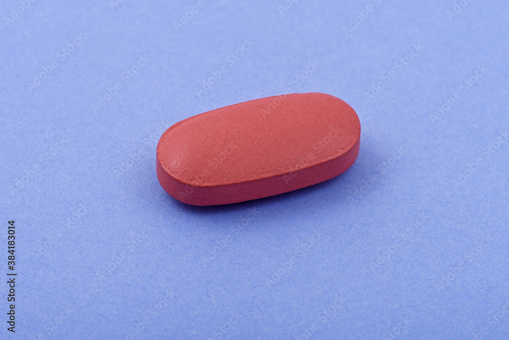 Oval shape Pharmaceutical medicine tablet on blue background, Flat lay. Copy space. Medicine concepts. Minimalistic abstract concept. Light blue color background Oval shape Pharmaceutical medicine tablet on blue background, Flat lay. Copy space. Medicine concepts. Minimalistic abstract concept. Light blue color background