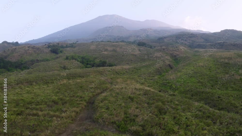 Beautiful aerial view of tranquil hills with misty mountain background in Kuningan, Indonesia. Shot in 4k resolution from drone flying upwards Beautiful aerial view of tranquil hills with misty mountain background in Kuningan, Indonesia. Shot in 4k resolution from drone flying upwards