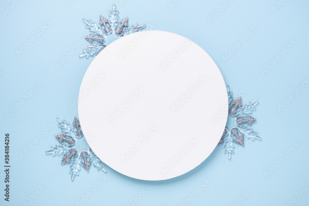 Christmas composition with silver gifts. White paper blank circle shape on blue background. Christmas template. Flat lay, top view, copy space