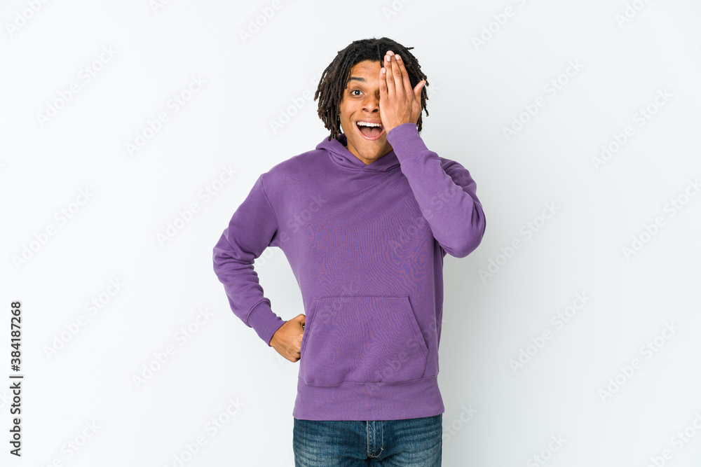 Young african american rasta man having fun covering half of face with palm. Young african american rasta man having fun covering half of face with palm.