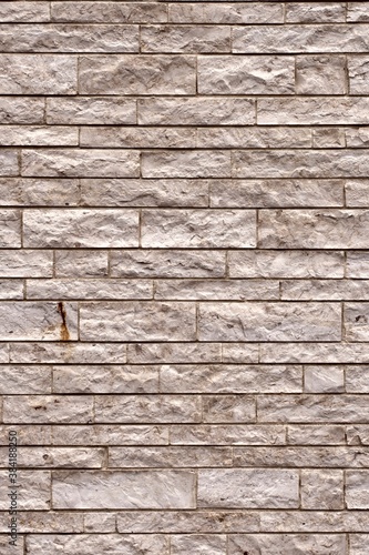 Sandstone brick wall. Vertical background texture. 