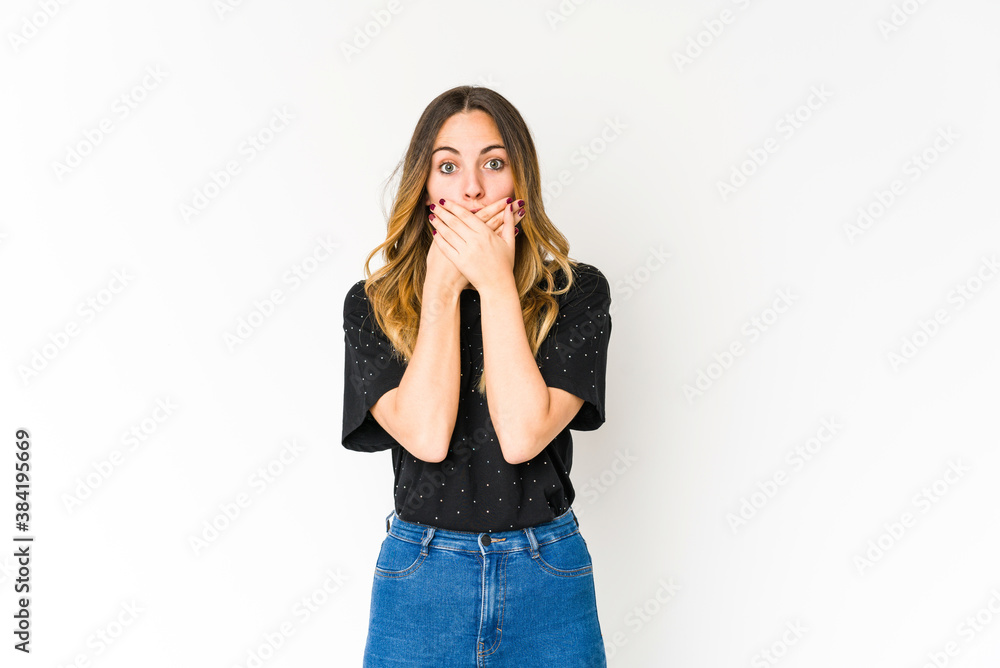 Young caucasian woman isolated on white background shocked covering mouth with hands. Young caucasian woman isolated on white background shocked covering mouth with hands.