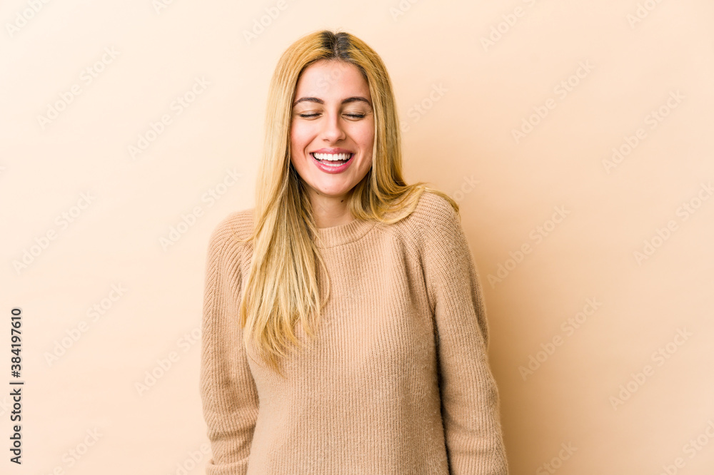 Young blonde caucasian woman laughs and closes eyes, feels relaxed and happy. Young blonde caucasian woman laughs and closes eyes, feels relaxed and happy.