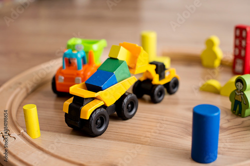 Colored wooden blocks toy. Wooden train and on a railway and other machines in composition.