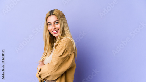 Young blonde caucasian woman who feels confident, crossing arms with determination.