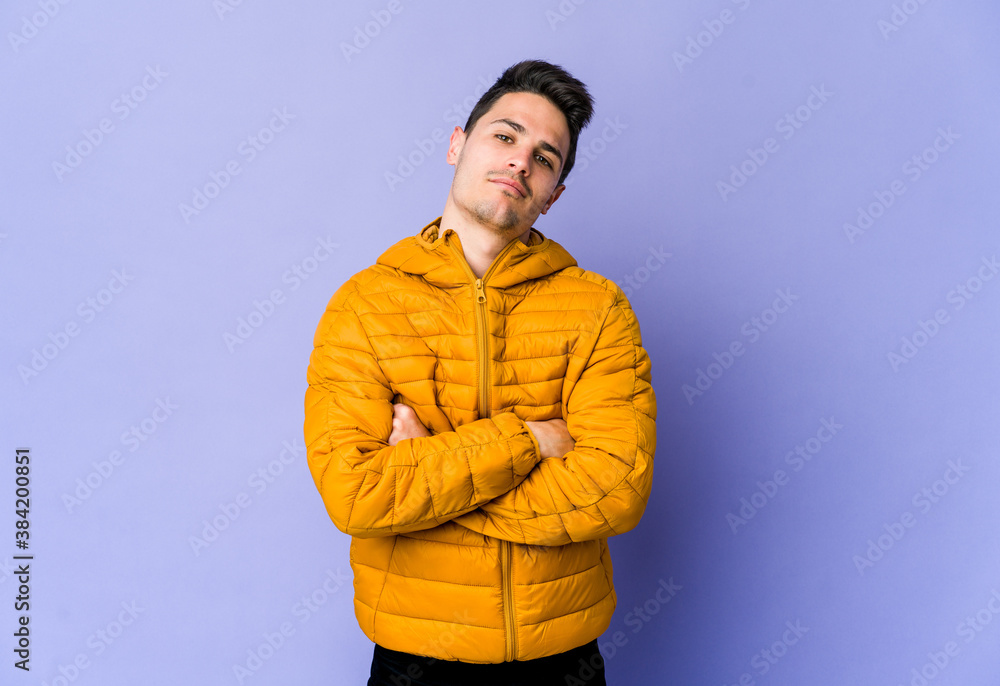 Young caucasian man isolated on purple background who is bored, fatigued and need a relax day. Young caucasian man isolated on purple background who is bored, fatigued and need a relax day.