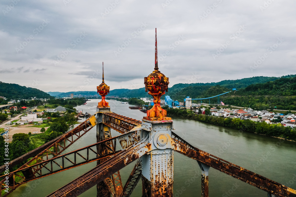 Fototapeta premium These are aerials showing the distinctive red spires atop the abandoned cantilevered Bellaire Interstate Toll Bridge crosses the Ohio River between Bellaire, Ohio, and Benwood, West Virginia.