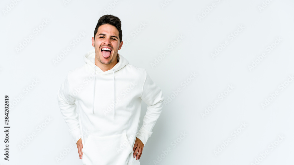 Young caucasian man isolated on white background funny and friendly sticking out tongue. Young caucasian man isolated on white background funny and friendly sticking out tongue.