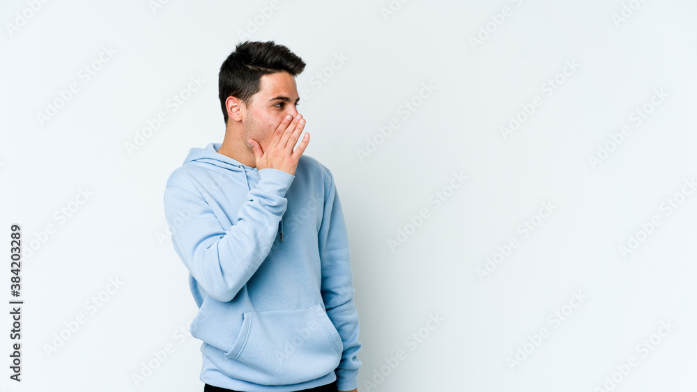 Young caucasian man isolated on white background being shocked because of something she has seen. Young caucasian man isolated on white background being shocked because of something she has seen.