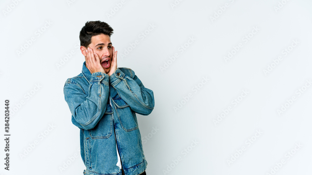 Young caucasian man isolated on white background scared and afraid.