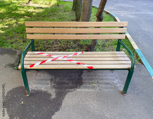 A bench covered with restraining tape. Social distancing. Moscow