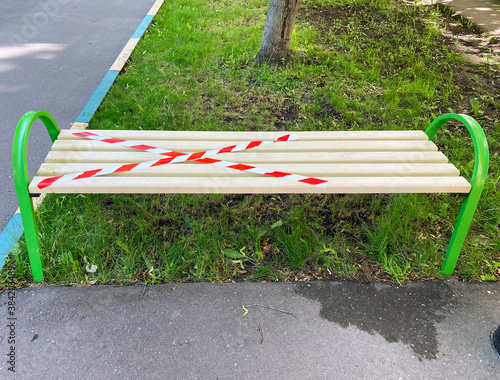 A bench covered with restraining tape. Social distancing. Moscow