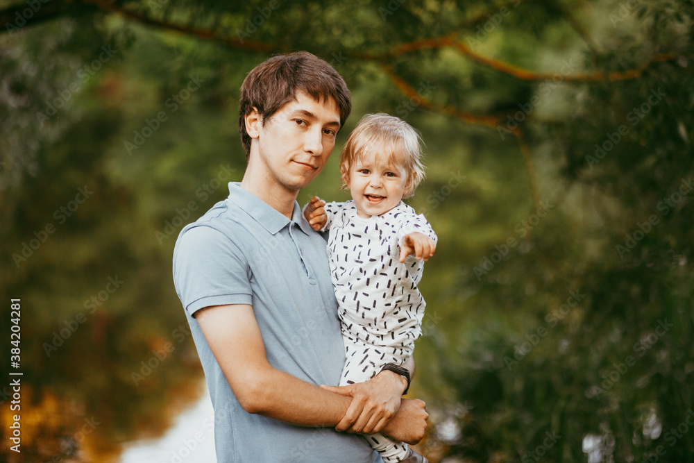 happy family father and son walking in nature happy family father and son walking in nature