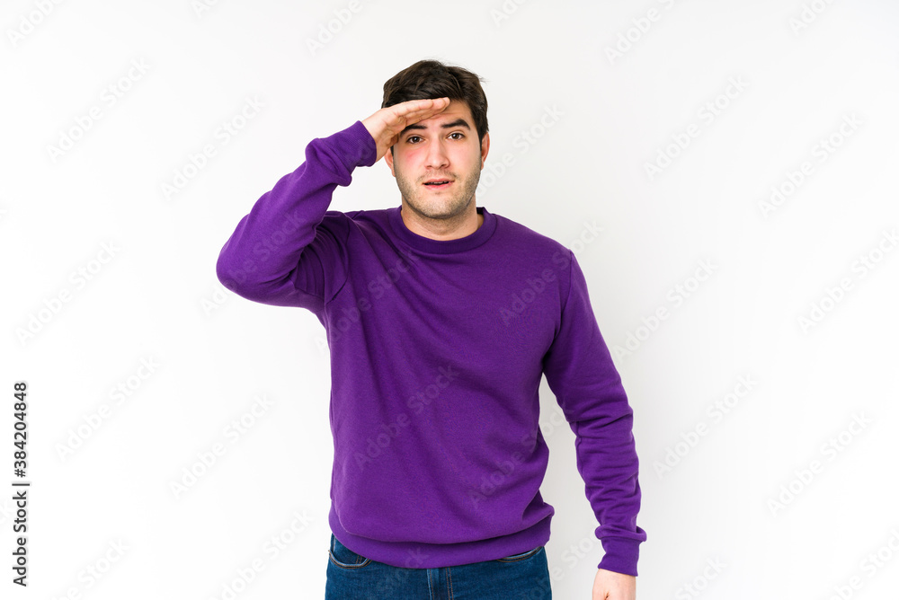 Young man isolated on white background shouts loud, keeps eyes opened and hands tense. Young man isolated on white background shouts loud, keeps eyes opened and hands tense.
