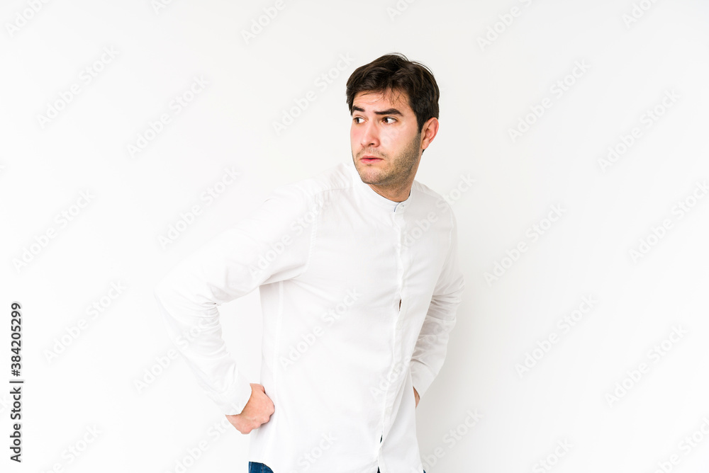 Young man isolated on white background looks aside smiling, cheerful and pleasant. Young man isolated on white background looks aside smiling, cheerful and pleasant.
