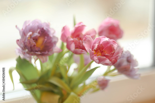 a bouquet of delicate pink flowers on the window, fading roses, a bouquet of beautiful flowers