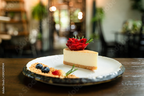 Close-up picture of delicious cakes on beautifully decorated ceramic plates and bokeh background.