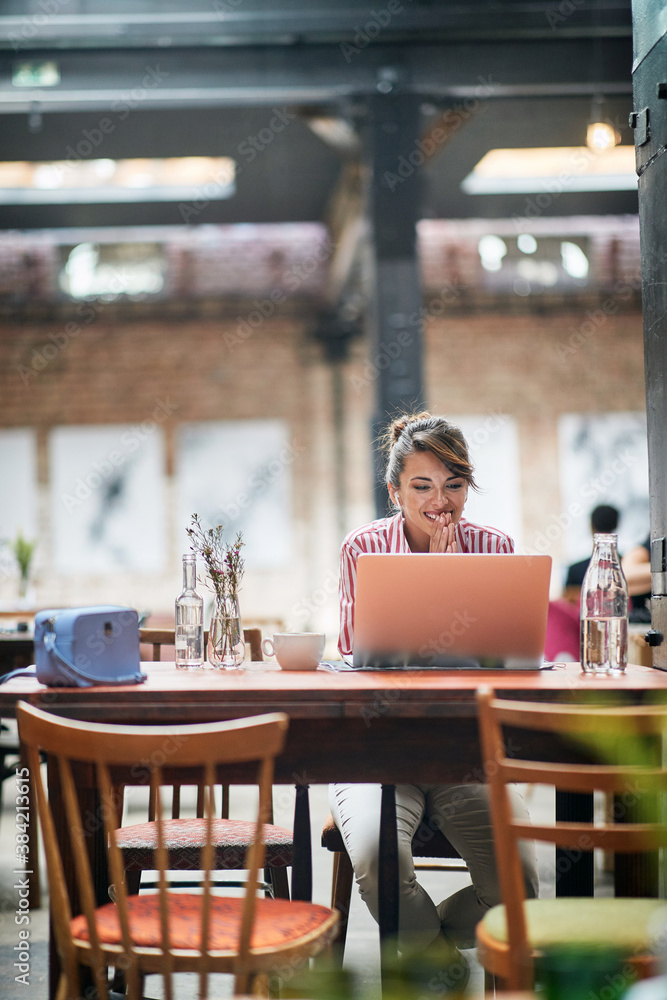 Young beautiful girl enjoying laptop content Young beautiful girl enjoying laptop content