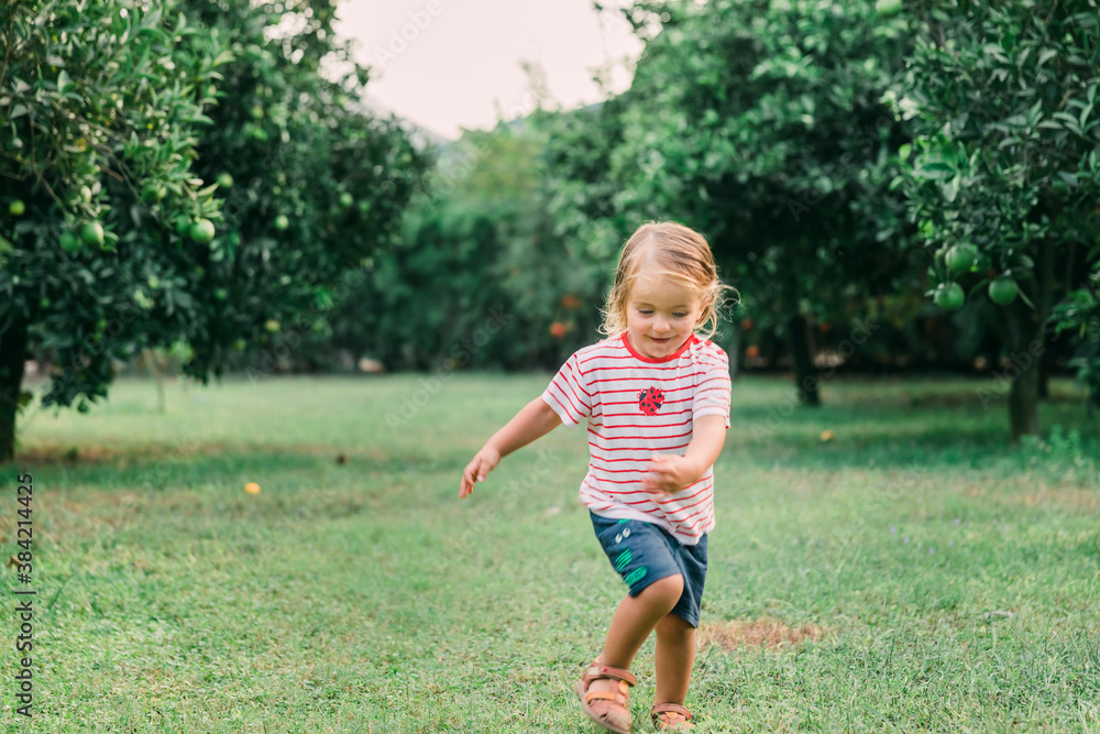 Toddler girl running in garden Toddler girl running in garden