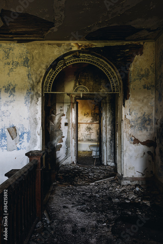 This is an interior view of the second floor foyer with a unique arch opening at the long-abandoned and historic Dunnington Mansion in Farmville, Virginia.