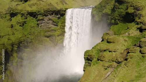 Aerial: Skogafoss Waterfall in the South of Iceland Magnificent natural wonder High water cascades Popular tourist attraction Beautiful sunny day 