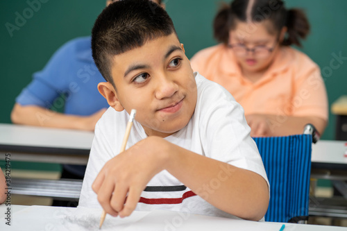 disability kid on wheelchair with Autism child in special classroom