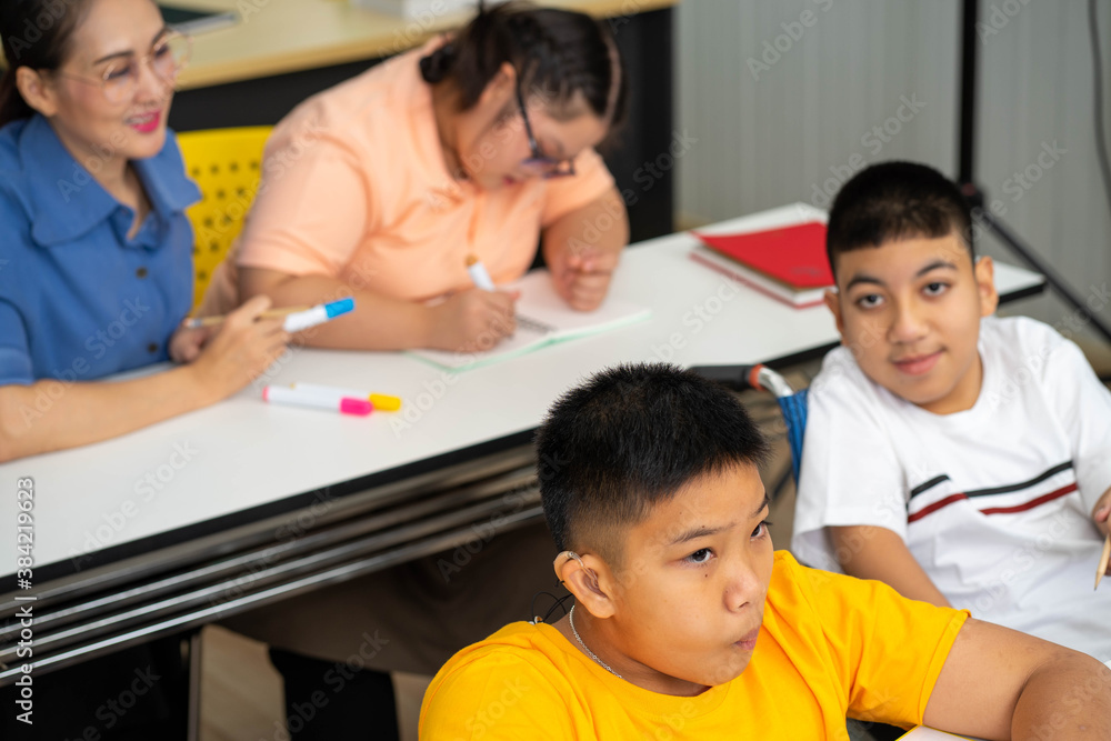 disability kid on wheelchair with Autism child in special classroom disability kid on wheelchair with Autism child in special classroom
