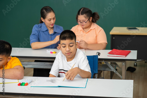disability kid on wheelchair with Autism child in special classroom