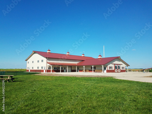Wallpaper Mural Red roof barn on the farm, with a bright blue sky in the background and lush green grass in the front Torontodigital.ca