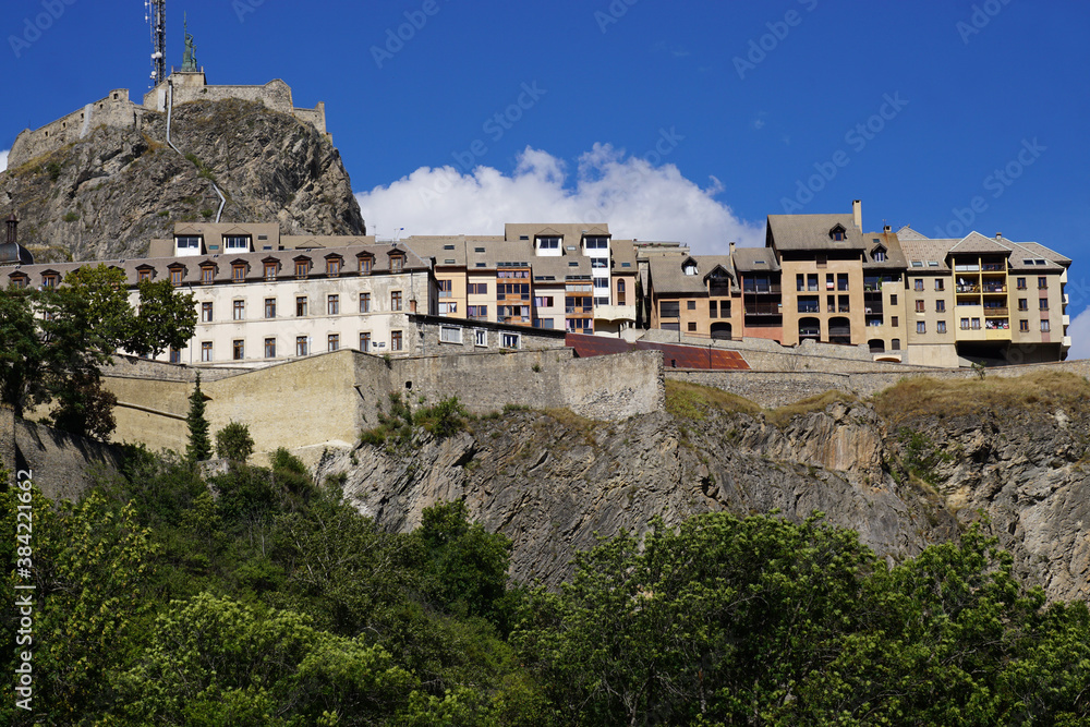 view of the fortifications of the town of Briançon, France with the colorful houses