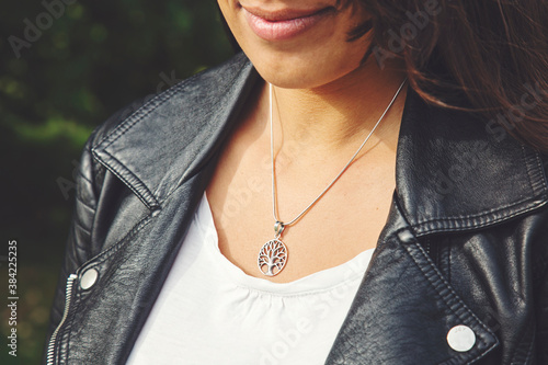 Φωτογραφία Female neckline wearing tiny silver chain with silver pendant in the shape of tr