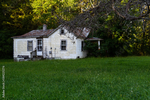 This is an exterior view of an abandoned white painted house in rural Virginia.