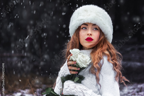 Beautiful girl in a white fur hat in the forest. Fabulous photo. Russian. In the role of Anna Karenina. New Year's, snowy photo session. photo