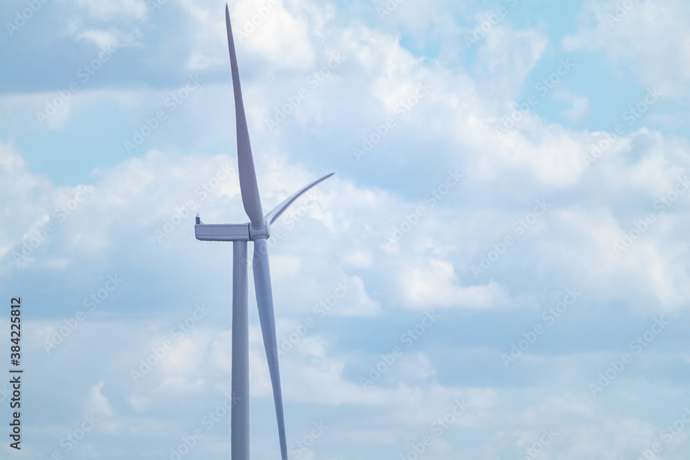 Wind generator propeller close-up on farm sustainable industry. Cloudy blue sky cloudscape with Energy turbines power Wind generator propeller close-up on farm sustainable industry. Cloudy blue sky cloudscape with Energy turbines power