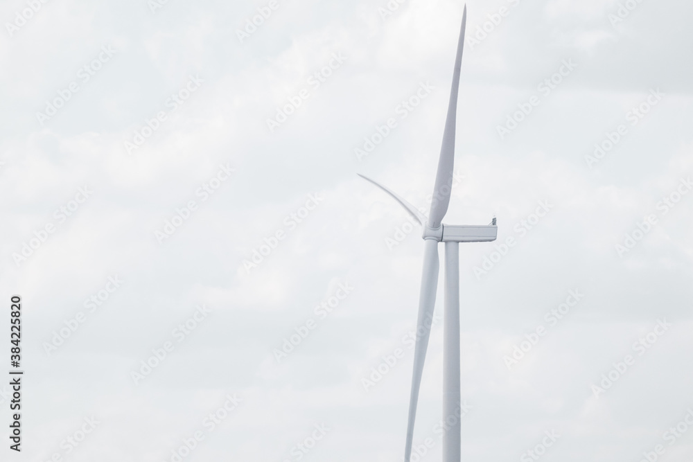 Wind generator propeller close-up on farm sustainable industry. Cloudy grey sky cloudscape with Energy turbines power Wind generator propeller close-up on farm sustainable industry. Cloudy grey sky cloudscape with Energy turbines power