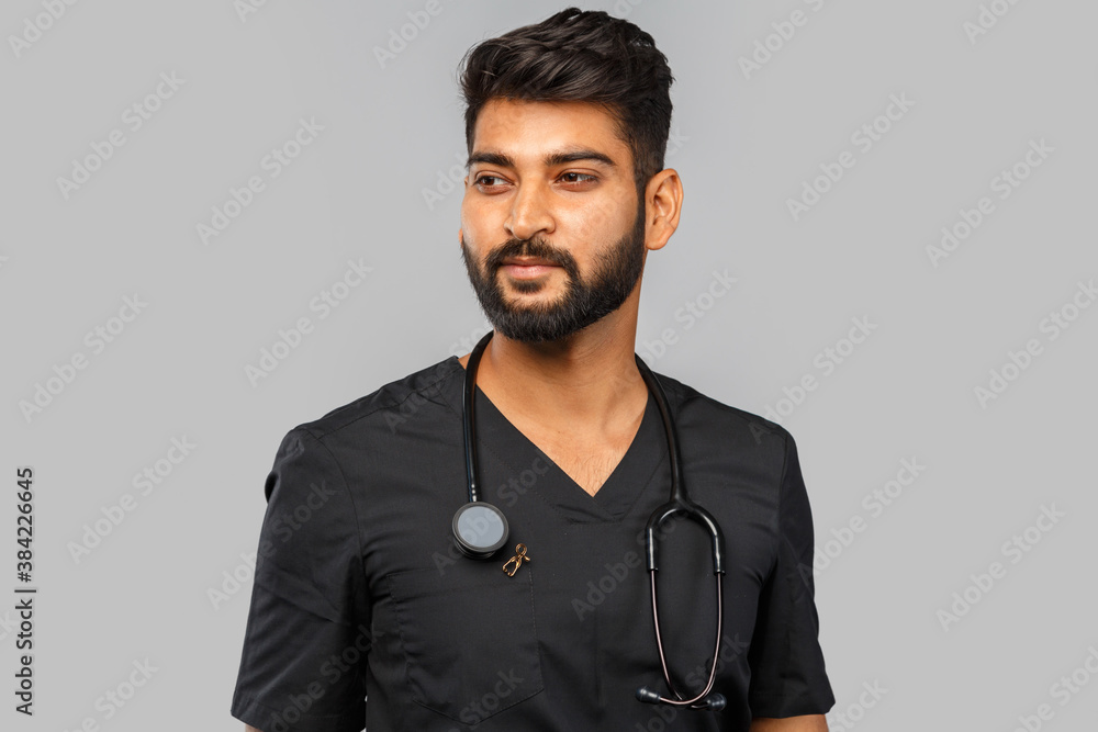 Obraz premium indian doctor or surgeon with stethoscope on gray background