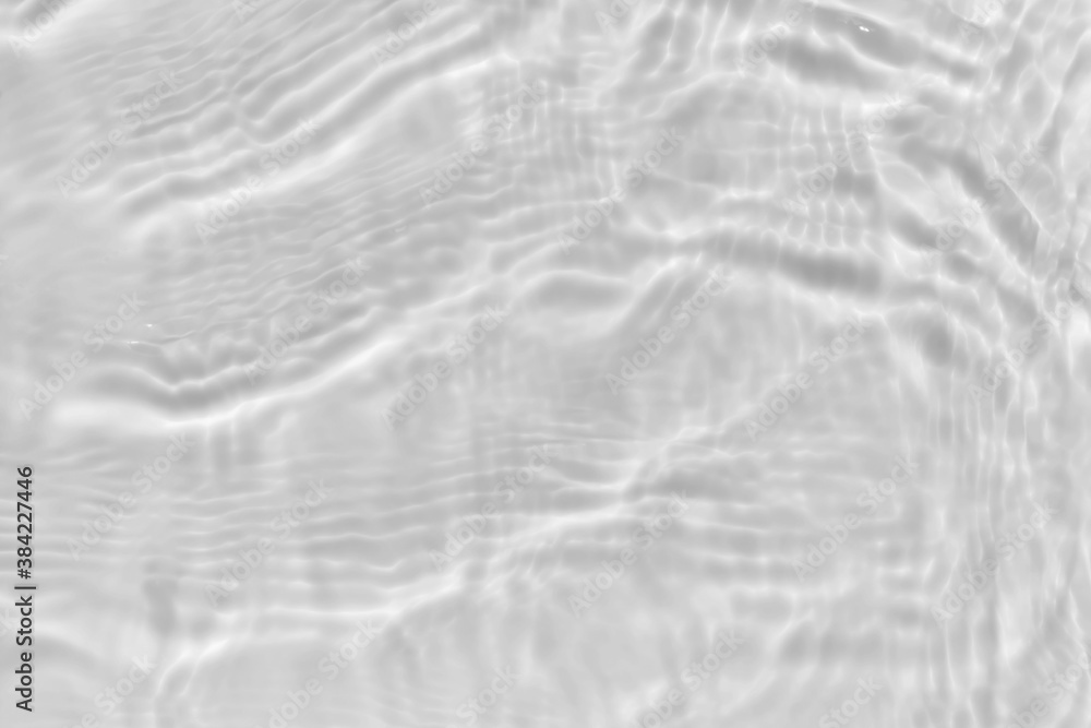 Subtle white texture of light-shadow pattern of sunlight reflection from rippled water surface. Beautiful natural wallpaper. Grayscale calm water waves. Subtle white texture of light-shadow pattern of sunlight reflection from rippled water surface. Beautiful natural wallpaper. Grayscale calm water waves.