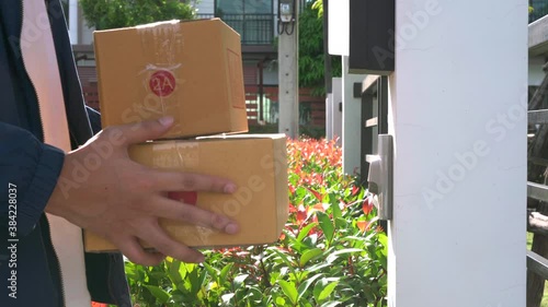 elivery man delivering a parcel packages to the door of customer during the COVID-19 photo