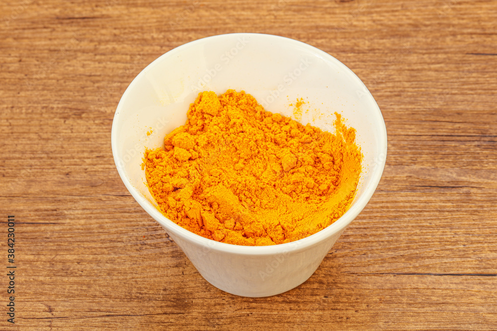 Tumeric powder in the bowl Tumeric powder in the bowl