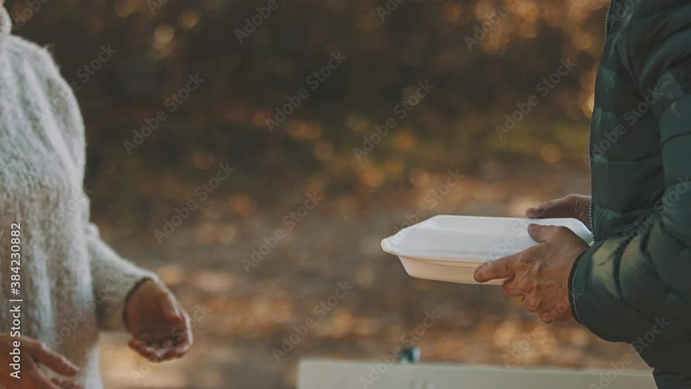 woman volunteer help feed the homeless with free meal. Close-Up. . High quality 4k footage