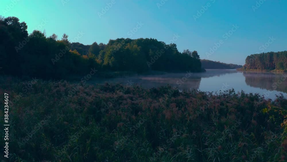 fog over the lake. the water evaporates and floats above the water in the morning sun. camera flies over reeds and foggy lake. evaporation over water fog over the lake. the water evaporates and floats above the water in the morning sun. camera flies over reeds and foggy lake. evaporation over water