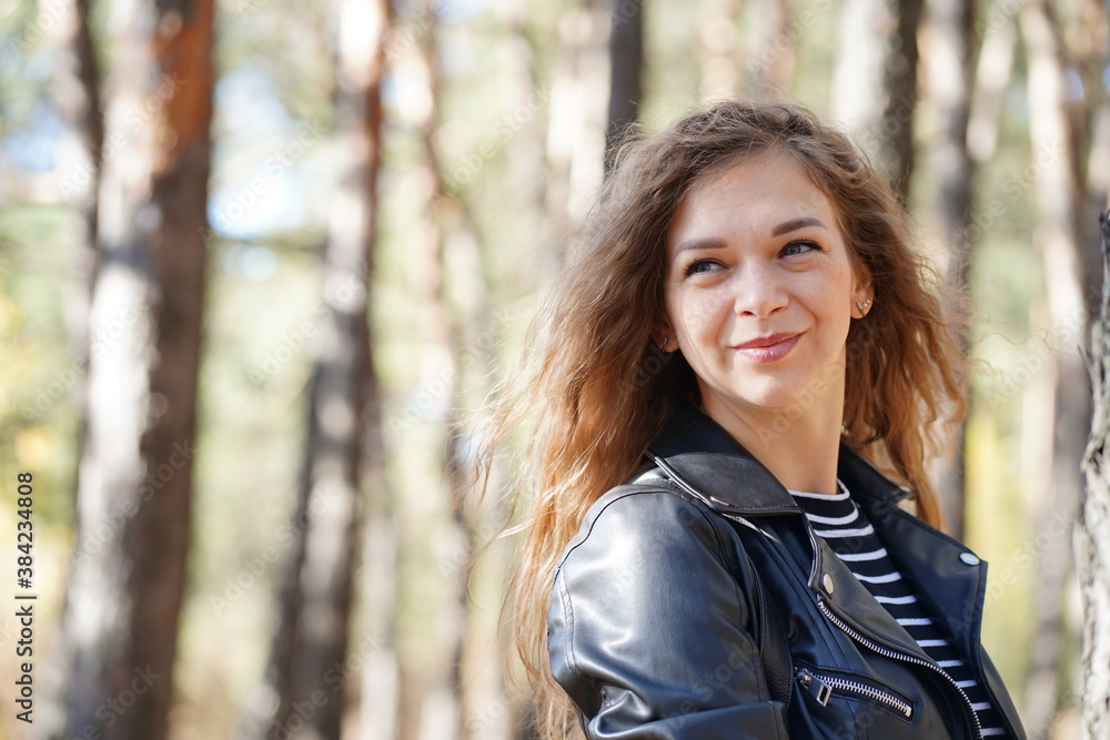 Close up of attractive young woman posing in wood. Charming female photographed on camera, standing in forest. Close up of attractive young woman posing in wood. Charming female photographed on camera, standing in forest.